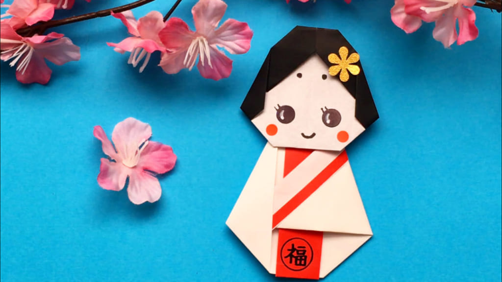 Oriya小町さんによるお福ちゃんの豆入れの折り紙